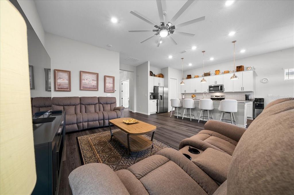 8750 Southwest 59th Ln Road Ocala, FL 34481 - Photo 22 of 41 a living room with furniture and a wooden floor