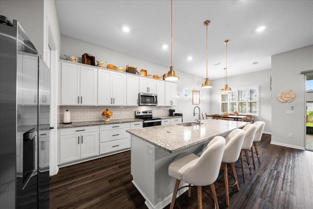 8750 Southwest 59th Ln Road Ocala, FL 34481 - Photo 24 of 41 a large kitchen with granite countertop lots of counter space and refrigerator
