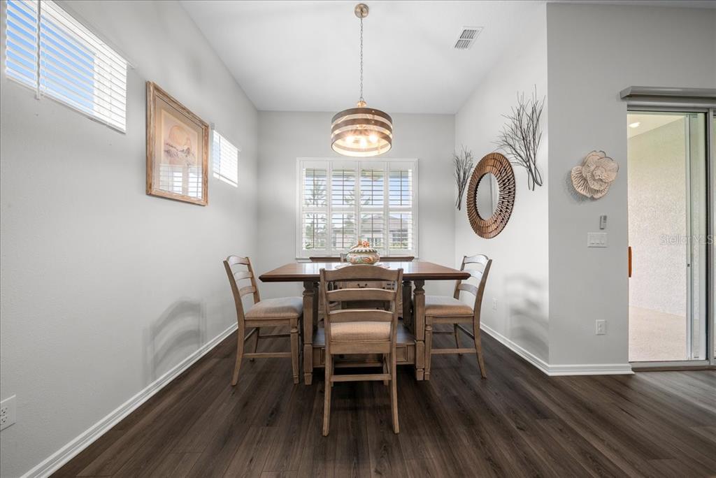 8750 Southwest 59th Ln Road Ocala, FL 34481 - Photo 28 of 41 a view of a dining room with furniture window and wooden floor