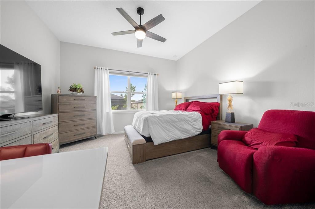8750 Southwest 59th Ln Road Ocala, FL 34481 - Photo 33 of 41 a spacious bedroom with a bed and a flat screen tv