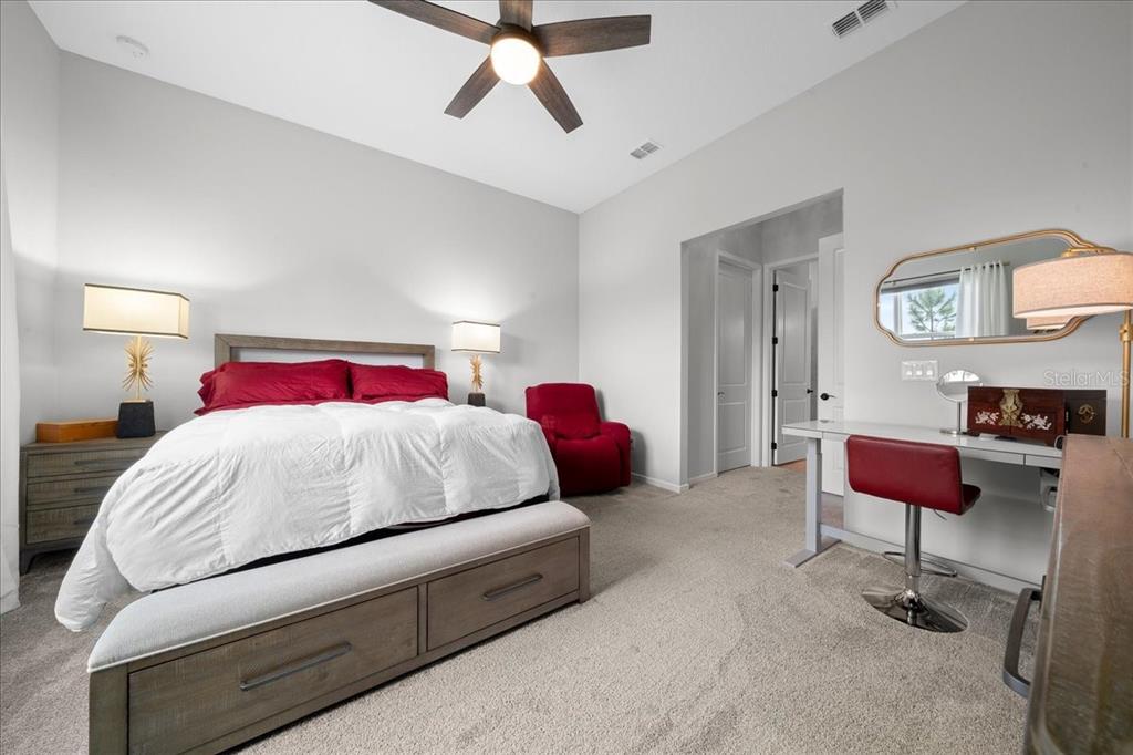 8750 Southwest 59th Ln Road Ocala, FL 34481 - Photo 34 of 41 a bedroom with a bed and a chandelier