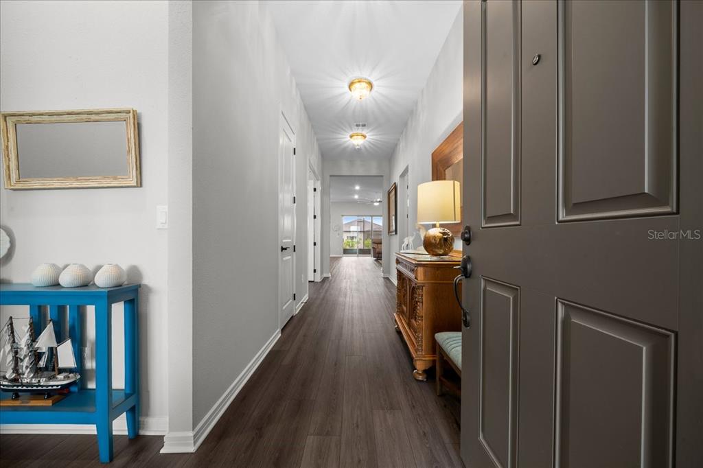 8750 Southwest 59th Ln Road Ocala, FL 34481 - Photo 8 of 41 a view of a hallway with wooden floor and staircase