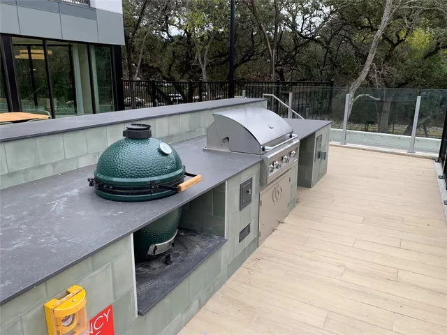 a kitchen with a sink a stove and a wooden floor