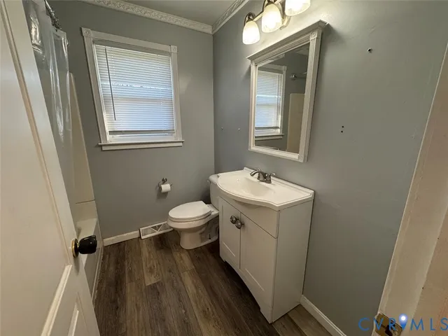 a bathroom with a sink toilet and mirror