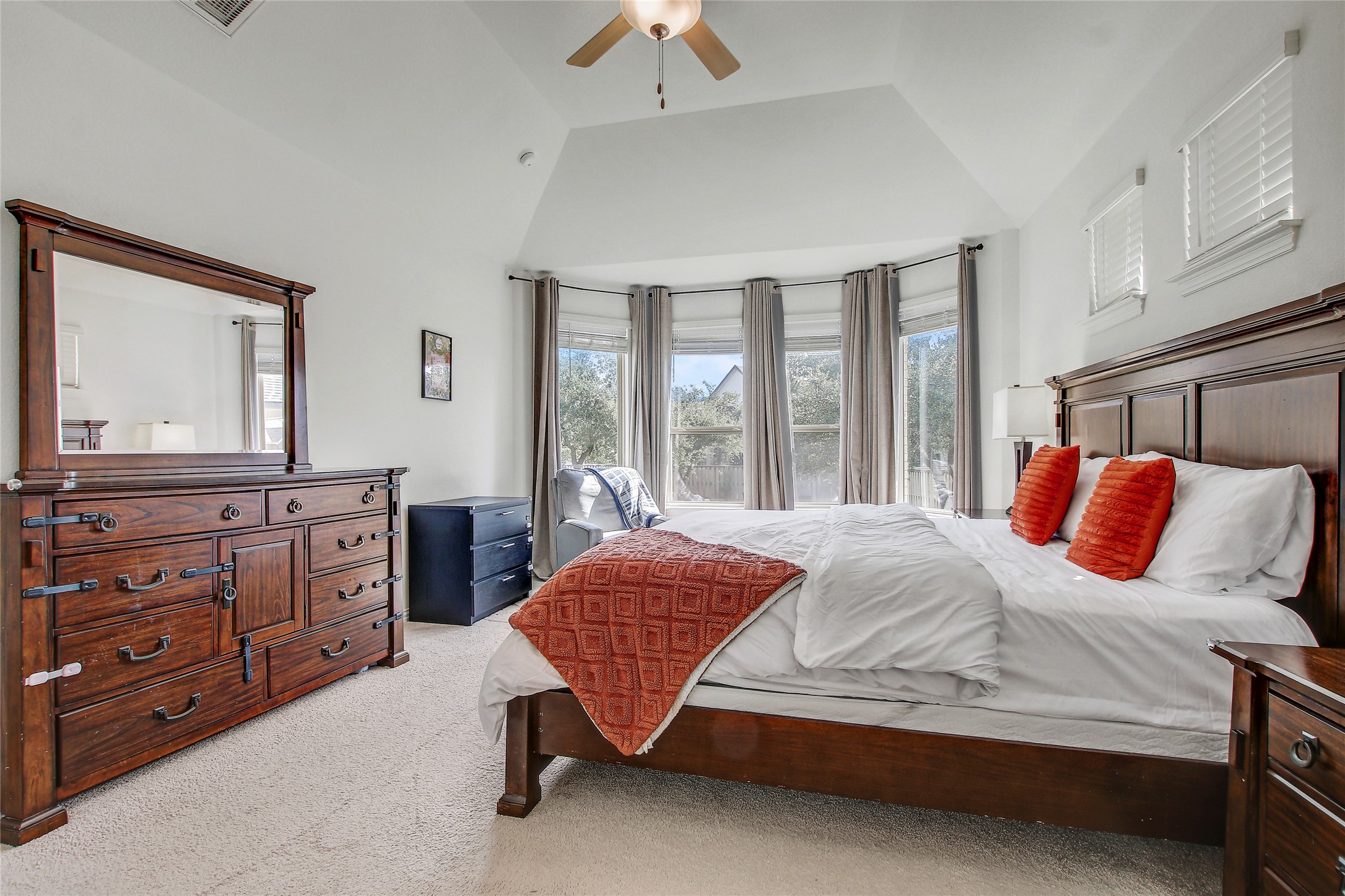 104 Millbend Road Georgetown, TX 78633 - Photo 19 of 40 Natural light floods this primary bedroom, featuring a generous bay window and vaulted ceiling.