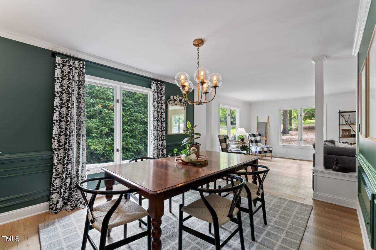 10817 Brass Kettle Road Raleigh, NC 27614 - Photo 18 of 55 a view of a dining room with furniture window and wooden floor