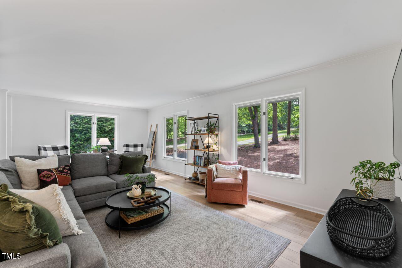 10817 Brass Kettle Road Raleigh, NC 27614 - Photo 22 of 55 a living room with furniture and a large window
