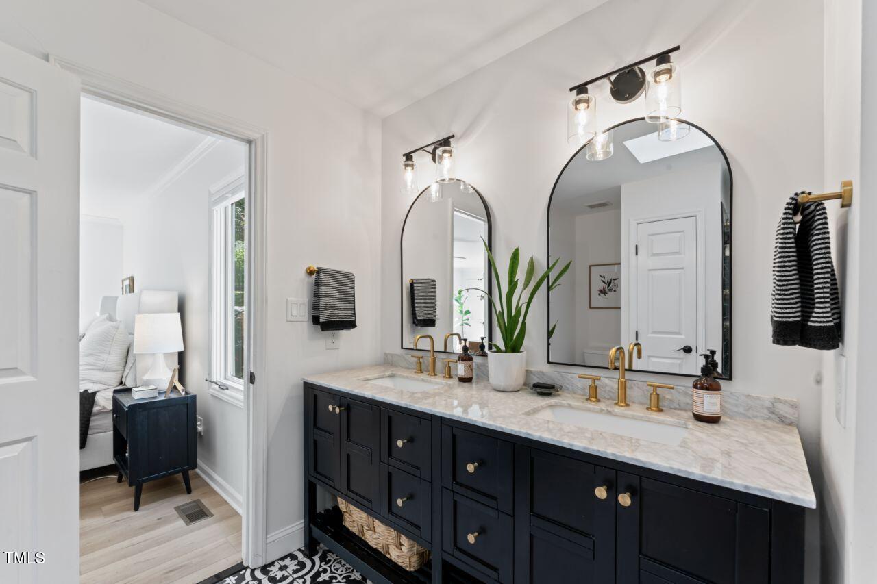 10817 Brass Kettle Road Raleigh, NC 27614 - Photo 26 of 55 a bathroom with a double vanity sink and a mirror