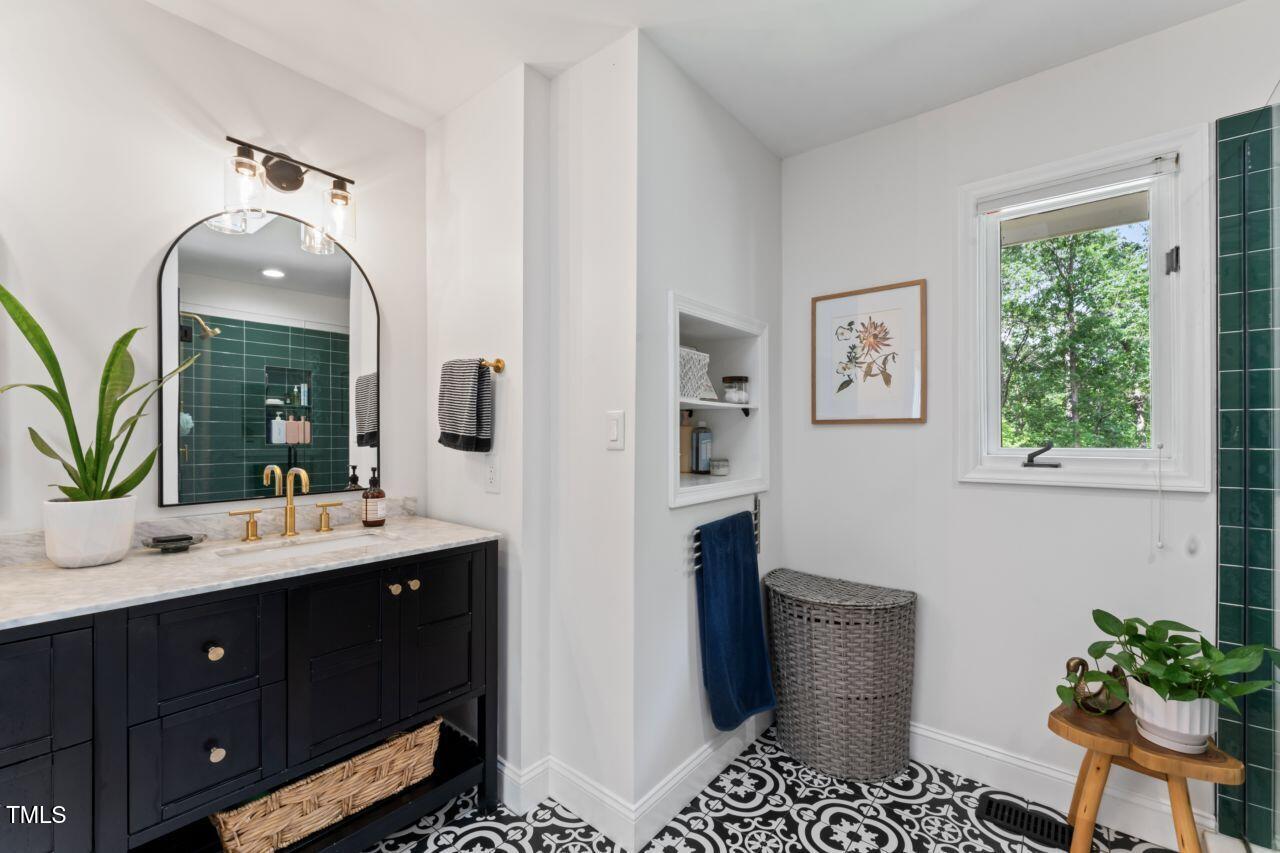 10817 Brass Kettle Road Raleigh, NC 27614 - Photo 28 of 55 a spacious bathroom with a sink a mirror and a toilet