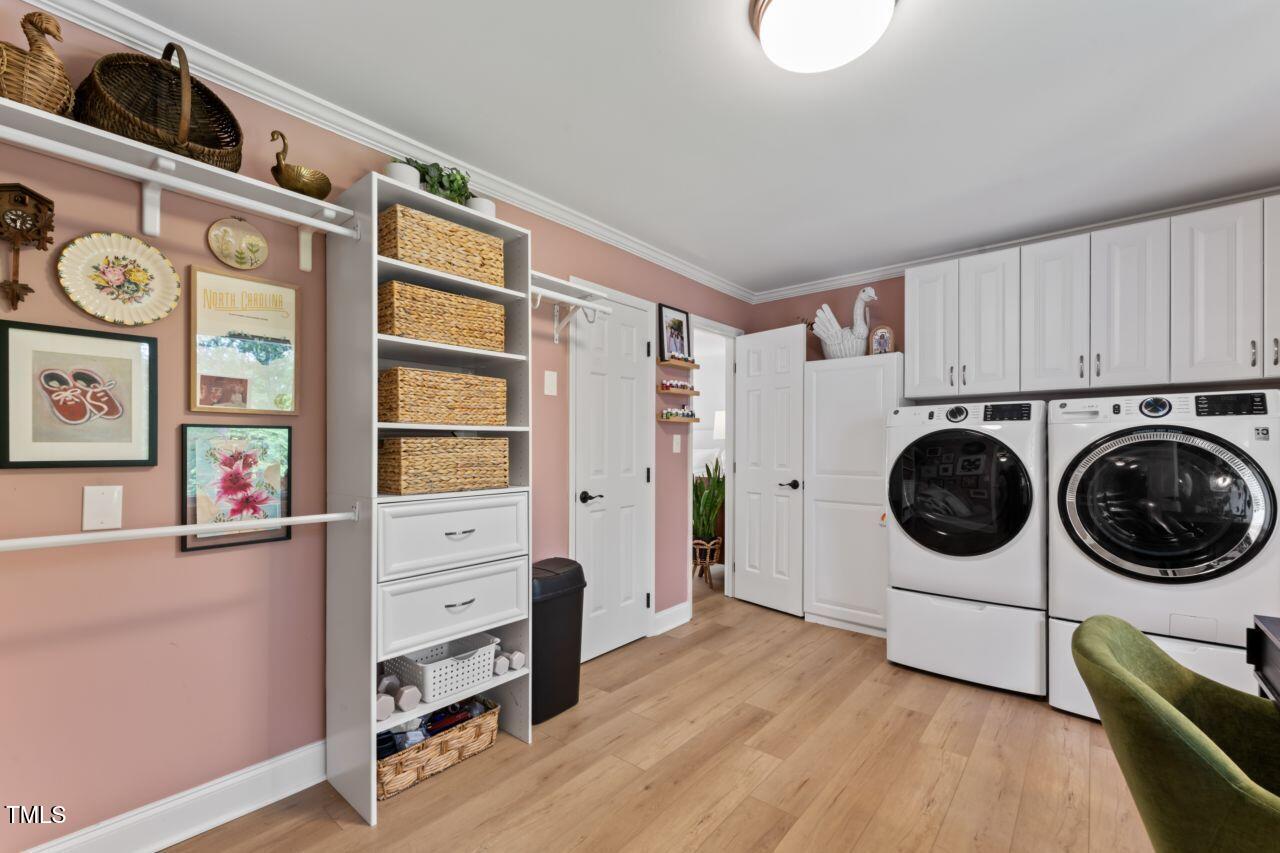 10817 Brass Kettle Road Raleigh, NC 27614 - Photo 29 of 55 a utility room with wooden floor washer and dryer