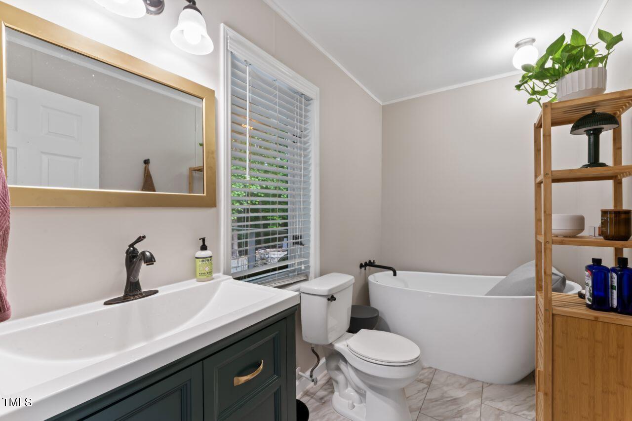 10817 Brass Kettle Road Raleigh, NC 27614 - Photo 42 of 55 a bathroom with a sink toilet vanity and tub