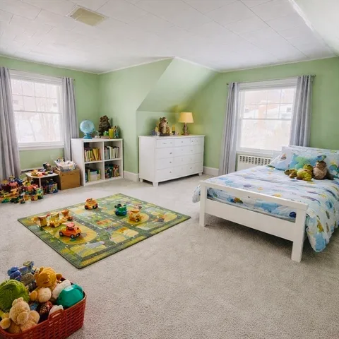 a bedroom with bed and window