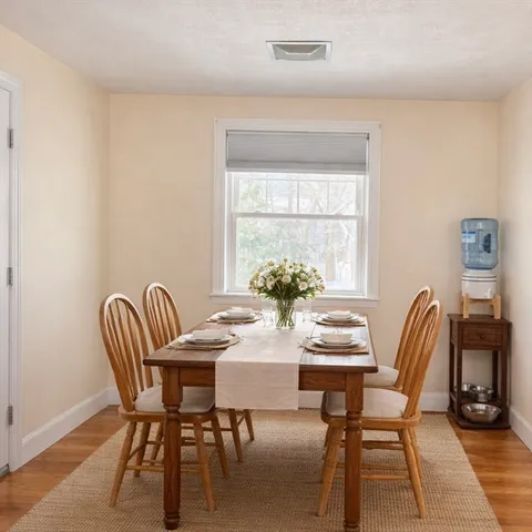 a dining room with furniture and window