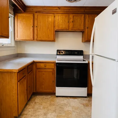 a kitchen with stainless steel appliances granite countertop a stove a microwave and a refrigerator