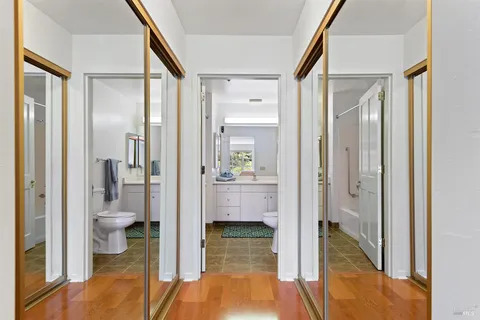 a view of a bathroom with tub and door