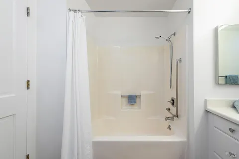 a bathroom with a shower and a bath tub