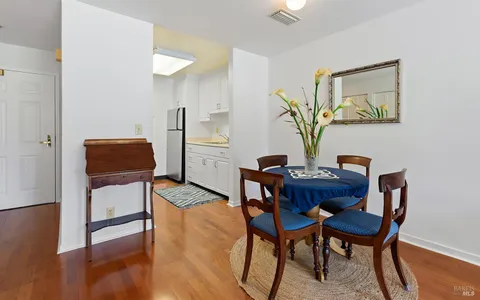 a view of a workspace with furniture and wooden floor