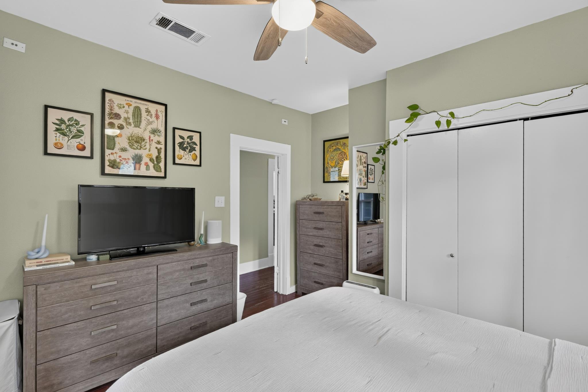 307 East 35th Street, Unit A Austin, TX 78705 - Photo 26 of 40 Hardwood floors and a ceiling fan create a serene and comfortable atmosphere in this well-appointed room.