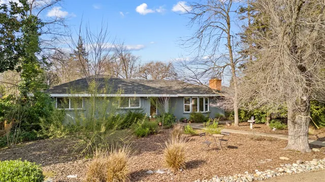 a front view of a house with a yard garage and outdoor seating