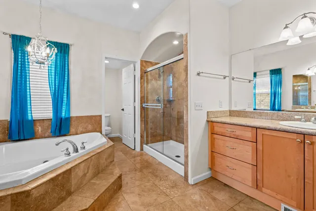 a bathroom with a tub shower and sink