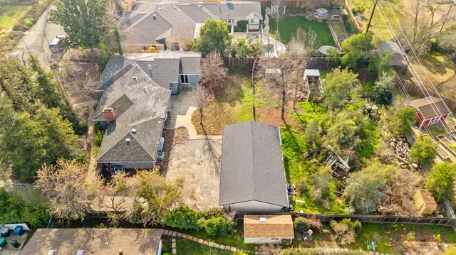 an aerial view of a house with a yard