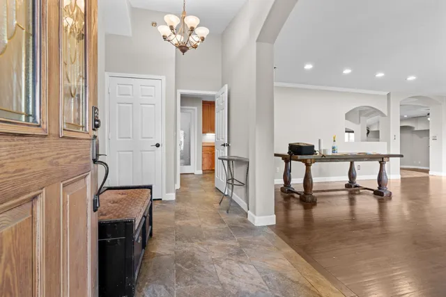 a view of a livingroom with furniture wooden floor and a chandelier