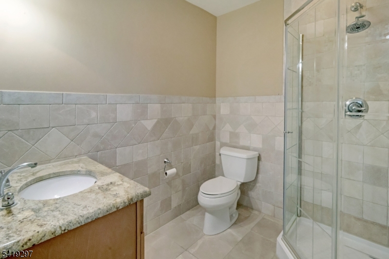 24 Pine Brook Road Montville, NJ 07082 - Photo 16 of 27 a bathroom with a granite countertop sink a toilet and shower