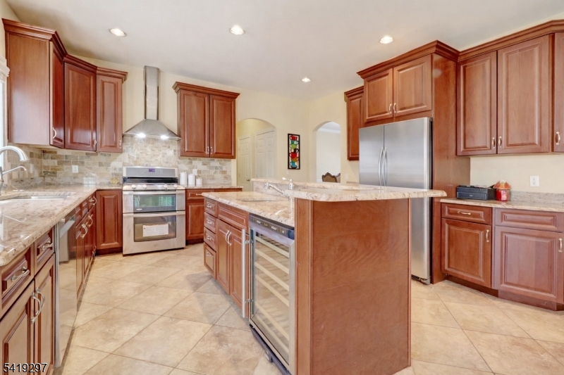 24 Pine Brook Road Montville, NJ 07082 - Photo 3 of 27 a kitchen with stainless steel appliances granite countertop a stove top oven a sink dishwasher and a refrigerator