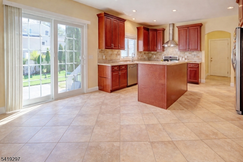 24 Pine Brook Road Montville, NJ 07082 - Photo 4 of 27 a kitchen with stainless steel appliances granite countertop a stove a sink and a refrigerator