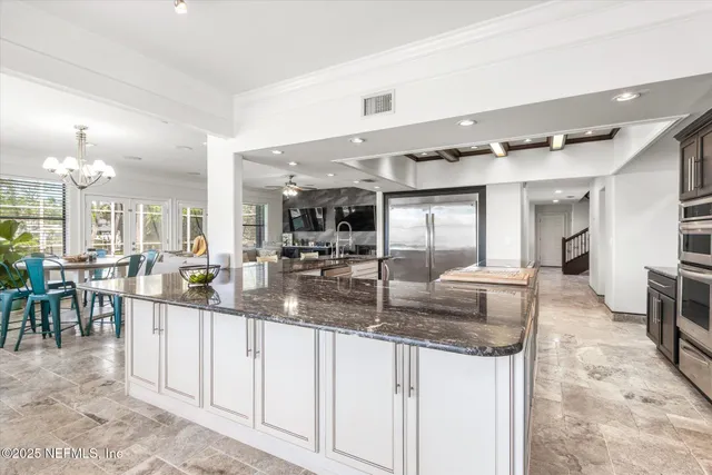 a kitchen with stainless steel appliances granite countertop a sink and cabinets