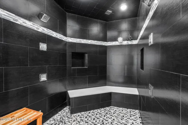 a bathroom with double vanity sink and a mirror