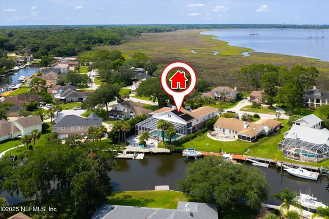 an aerial view of a house with a lake view