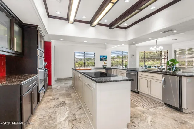 a kitchen with granite countertop a stove and cabinets