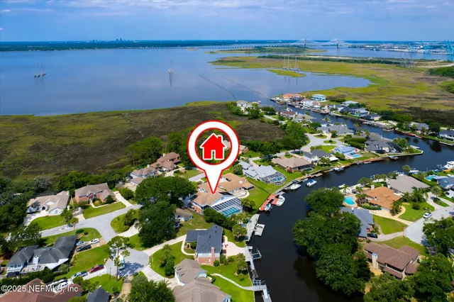 an aerial view of residential houses with outdoor space and swimming pool