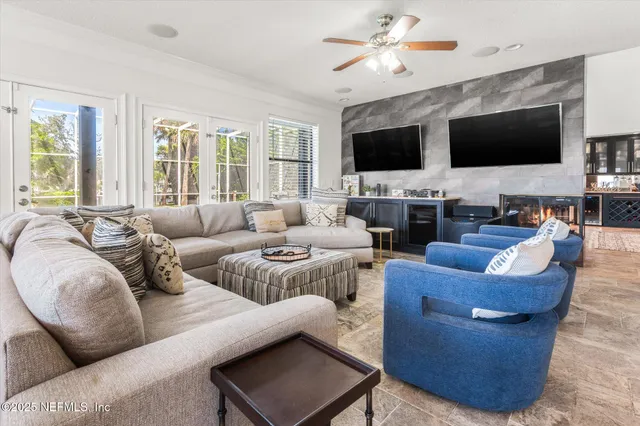 a living room with furniture fireplace and a flat screen tv