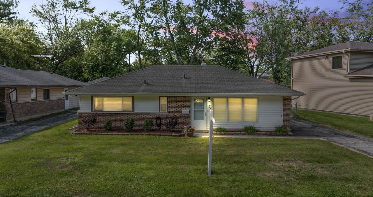 134 Monee Road Park Forest, IL 60466 - Photo 1 of 23 a front view of a house with a yard and trees