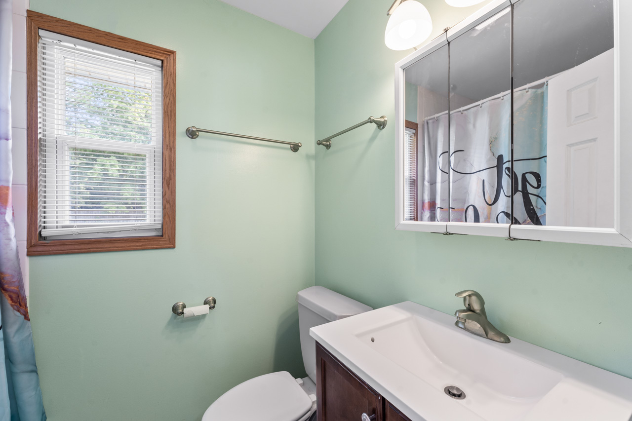 134 Monee Road Park Forest, IL 60466 - Photo 11 of 23 a bathroom with a sink a toilet and mirror