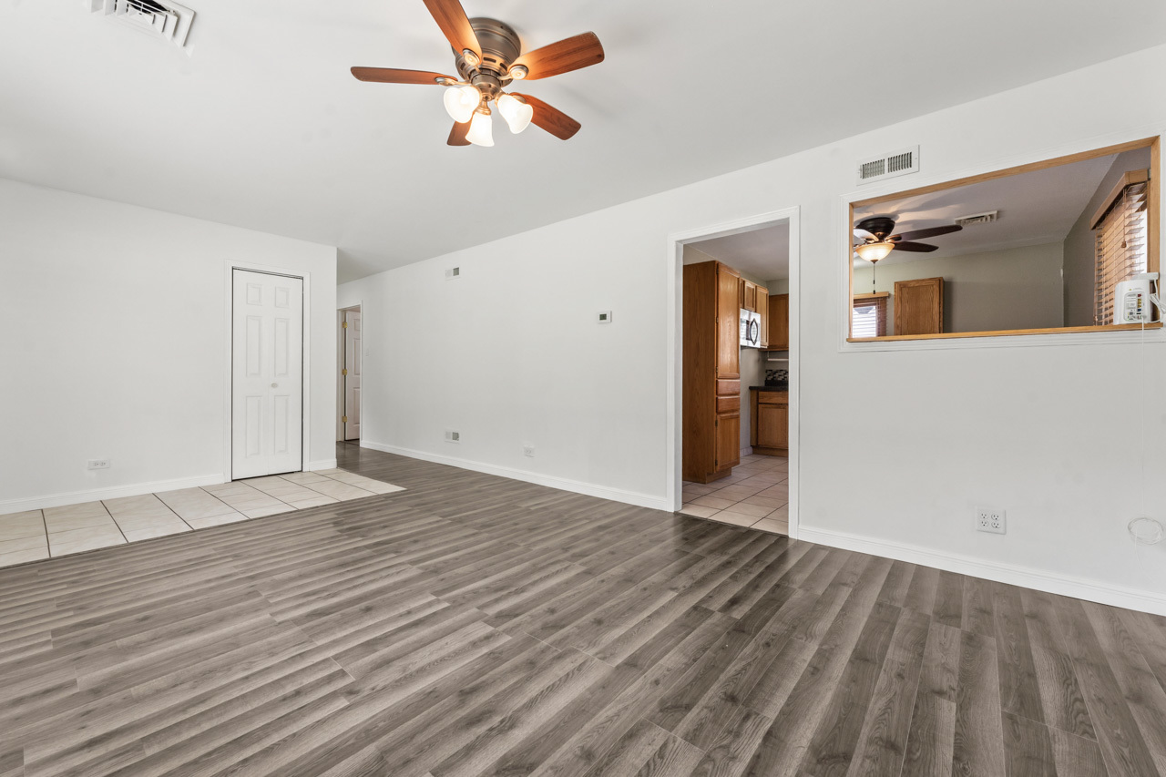 134 Monee Road Park Forest, IL 60466 - Photo 4 of 23 a view of empty room with wooden floor and fan