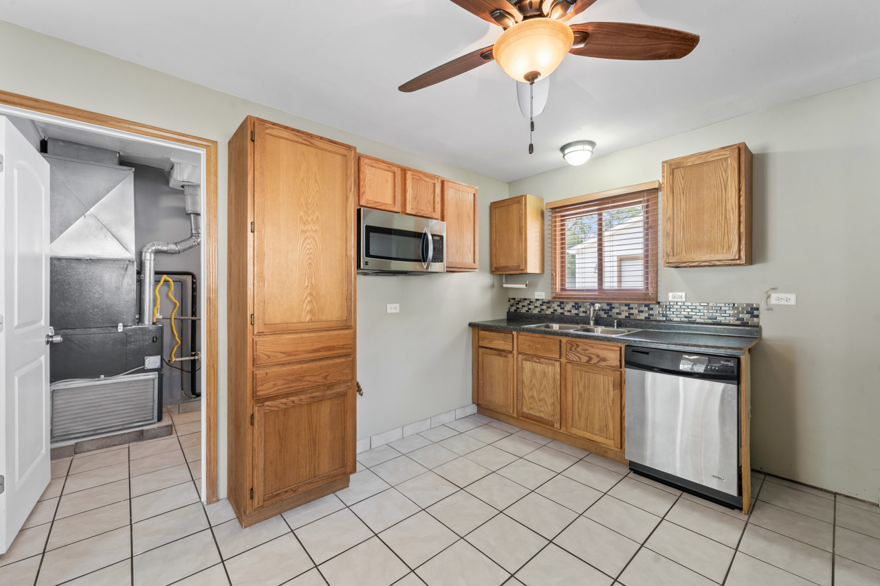 134 Monee Road Park Forest, IL 60466 - Photo 7 of 23 a kitchen with stainless steel appliances granite countertop a refrigerator and a sink