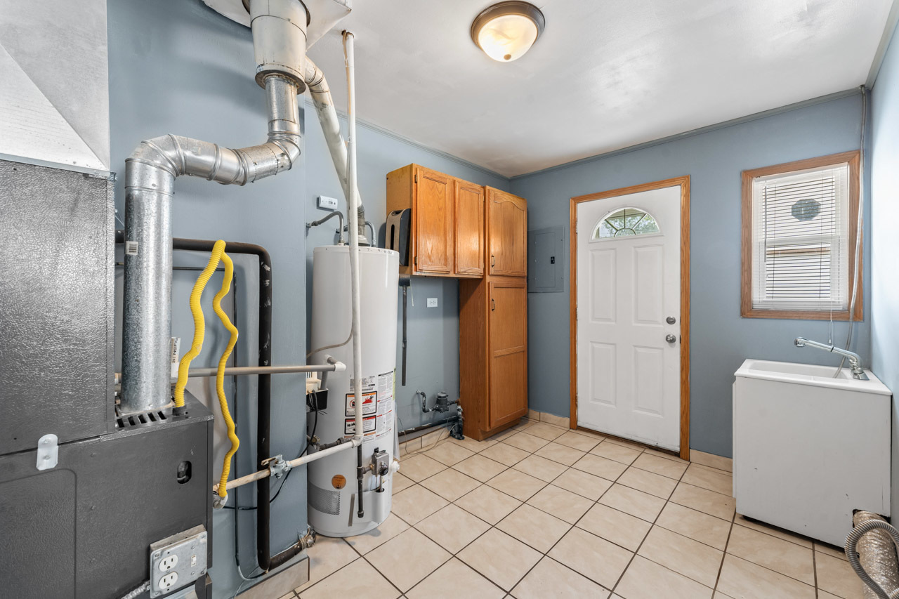 134 Monee Road Park Forest, IL 60466 - Photo 10 of 23 a view of walk in closet with clothes and shoes