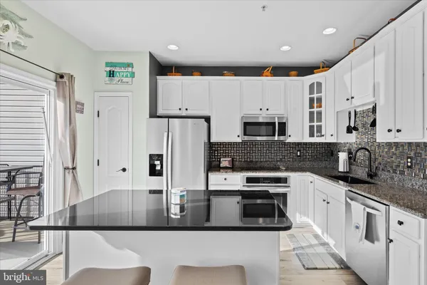 a kitchen with stainless steel appliances a stove a refrigerator and a oven