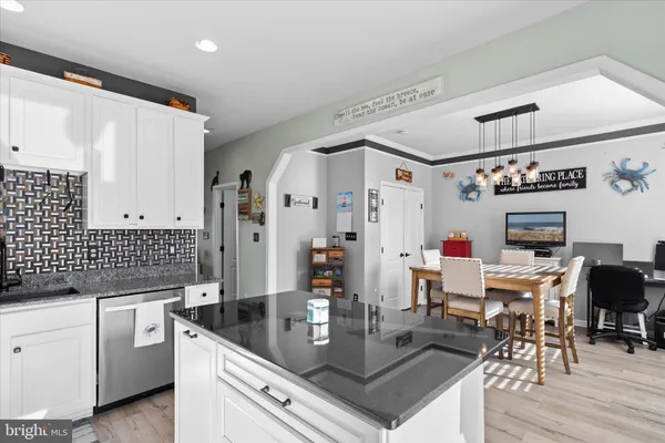 a kitchen with granite countertop a sink stove and refrigerator