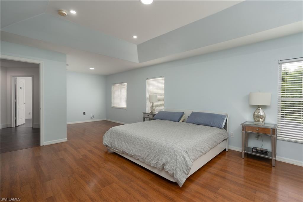 8271 Laurel Lakes Way Naples, FL 34119 - Photo 17 of 36 a bedroom with a bed and window