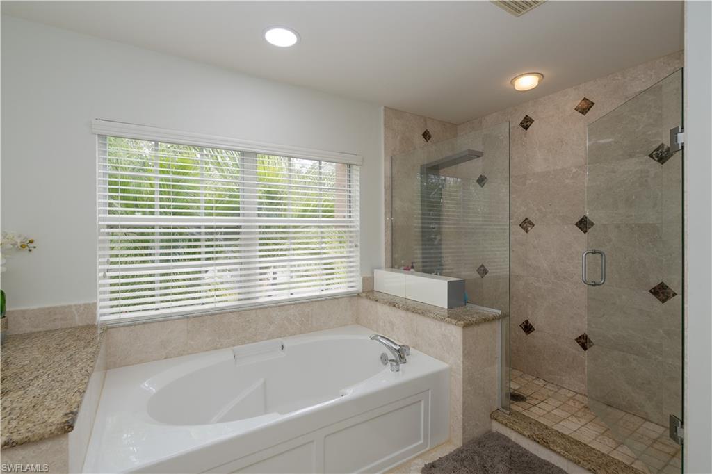 8271 Laurel Lakes Way Naples, FL 34119 - Photo 20 of 36 a bathroom with a bathtub a shower and a sink
