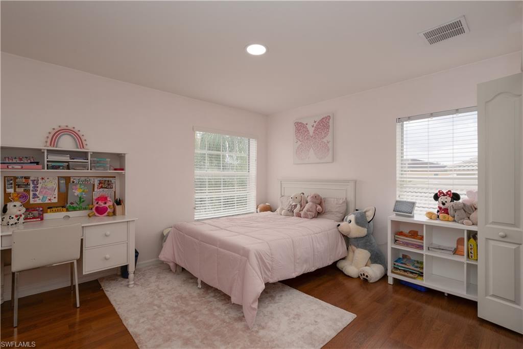 8271 Laurel Lakes Way Naples, FL 34119 - Photo 23 of 36 a bedroom with a bed and a window