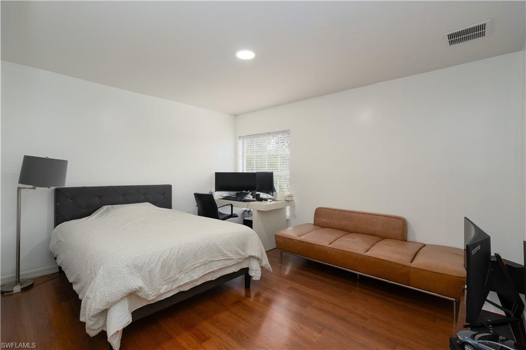 8271 Laurel Lakes Way Naples, FL 34119 - Photo 24 of 36 a bedroom with a bed and a couch