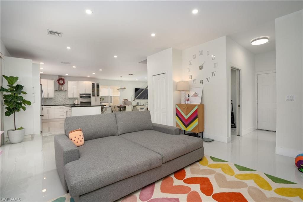 8271 Laurel Lakes Way Naples, FL 34119 - Photo 5 of 36 a living room with furniture and kitchen view
