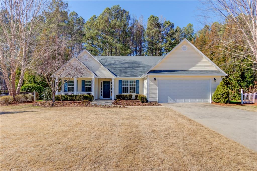 a front view of a house with a yard and trees