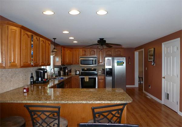 36 Gates Avenue Springfield, MA 01118 - Photo 8 of 24 a kitchen with stainless steel appliances granite countertop a sink refrigerator and microwave