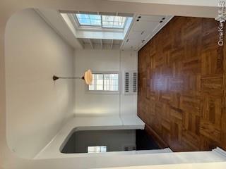 733 East Walnut Street, Unit UPPR Long Beach, NY 11561 - Photo 4 of 26 a view of an empty room and window